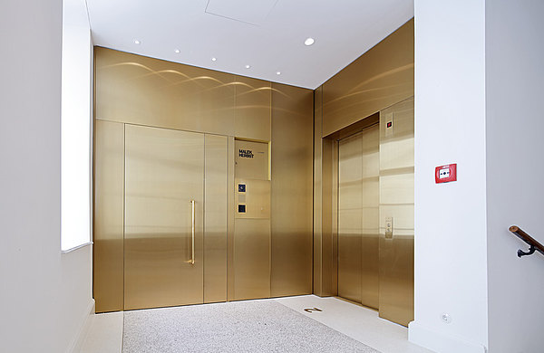 Brass covered fire-rated door EI30, made of forster fuego light steel profiles.