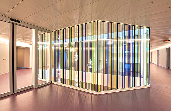 Fire-rated glazing forster fuego light EI60 with coloured foil stripes, which create a cheerful and light-floated atmosphere and at the same time offer high protection. 
Hospital Langenthal, Switzerland